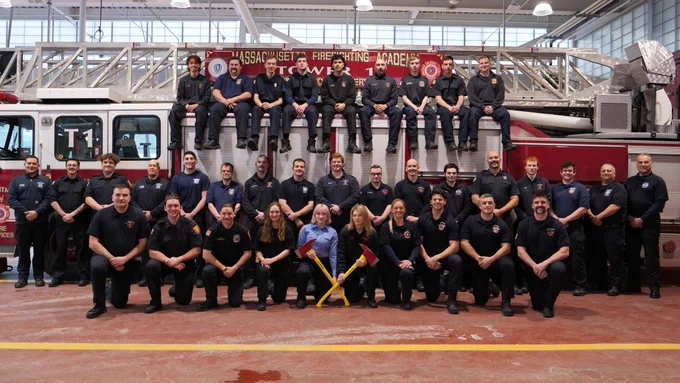 New firefighters on and around a ladder truck