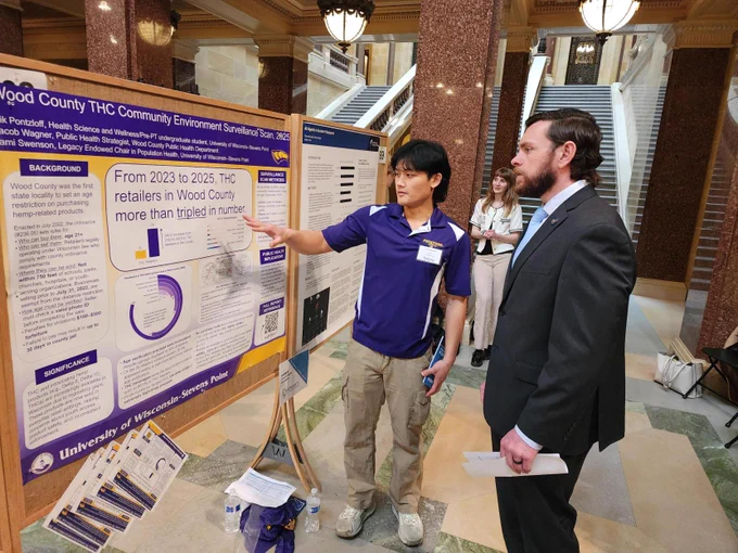 Student presenting research to legislator