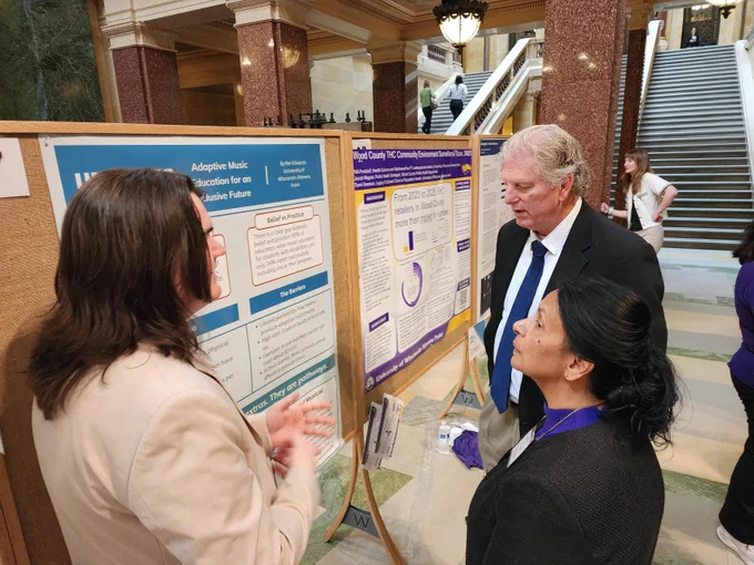 Student presenting research to interim chancellor and interim provost