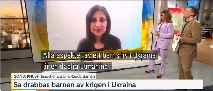 Image shows a woman being interviewed live on TV by a man and a woman
