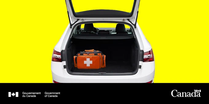 The back of a car with the trunk open, showing an emergency kit