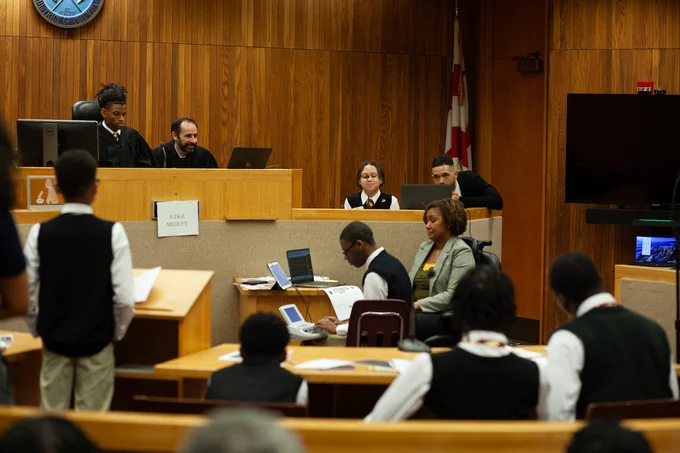 A 2026 Youth Law Fair student participant is sworn-in during the mock trial. 