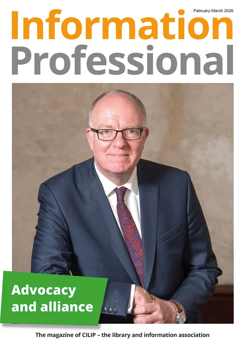 Cover of Information Professional magazine featuring a man in a dark suit and patterned tie against a neutral background.