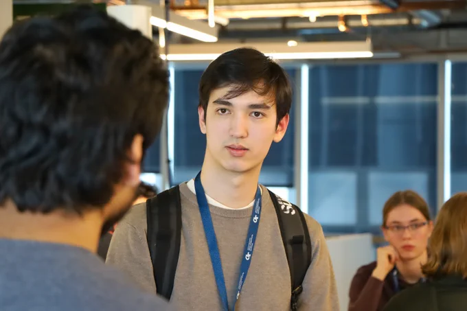 A male student looking at someone.