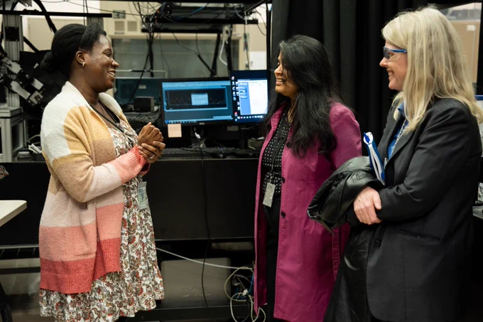 Photo of Dr. Bindu Nair, associate director of Basic Energy Sciences as the U.S. Department of Energy Office of Science, speaking with researchers in a lab at the Environmental Molecular Sciences Laboratory (EMSL).