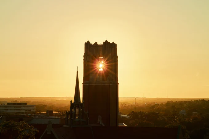 Century Tower at sunset with sun rays coming through the opening at the top.