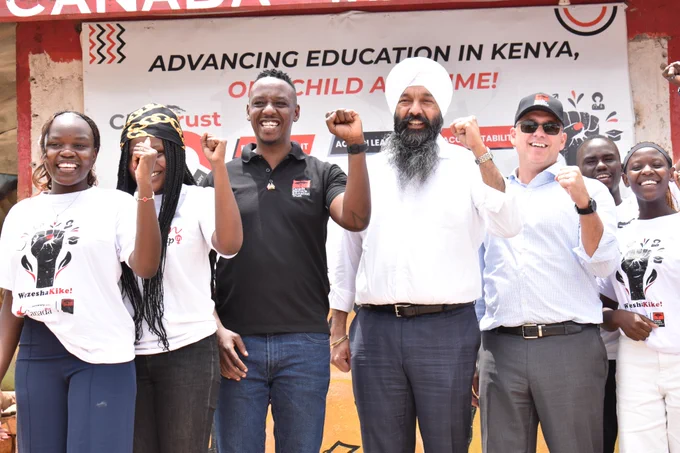 Secretary of State Randeep Sarai with CMETrust in Mathare. 