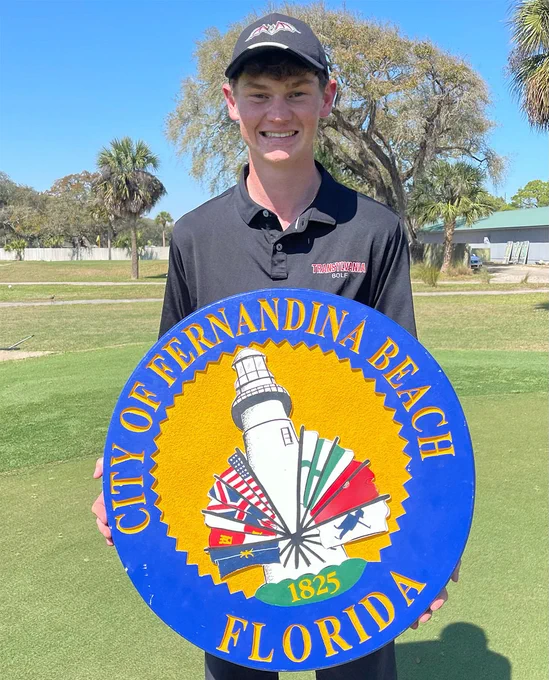 golfer holding a city logo