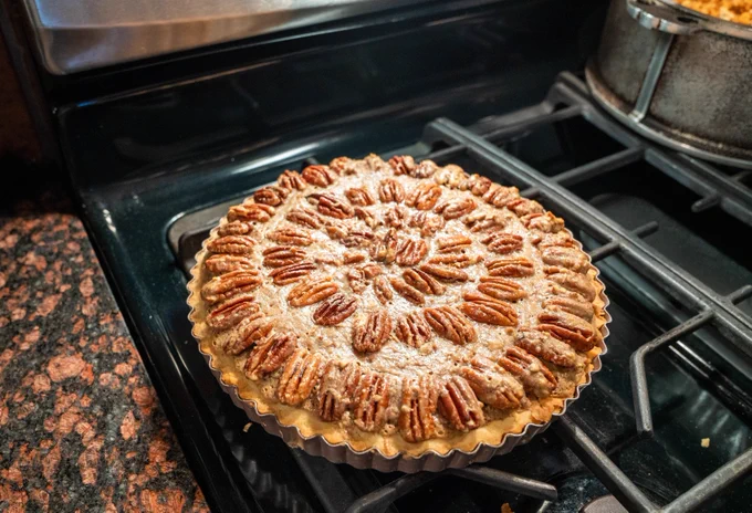 Home Made Pecan Pie cooling on gas stove 