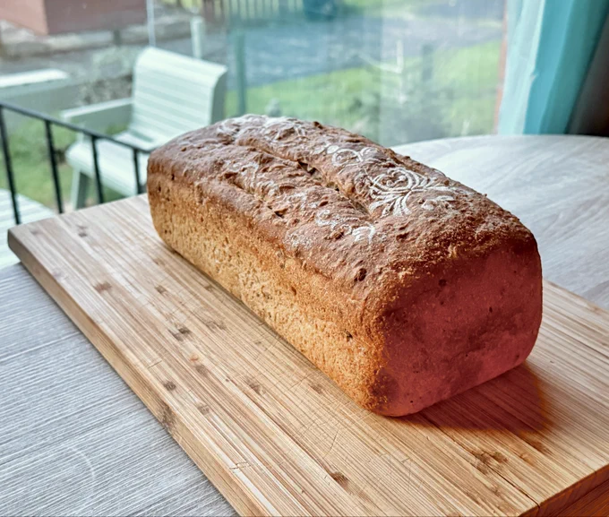 Homemade loaf sitting at the window, waiting to be sliced