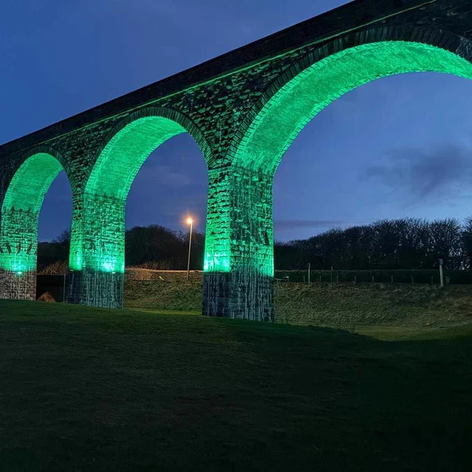 Cullen Viaduct lit up in teal against a dark blue sky and with a dark foreground - thanks to Cullen Christmas Lights and Davie Smith.