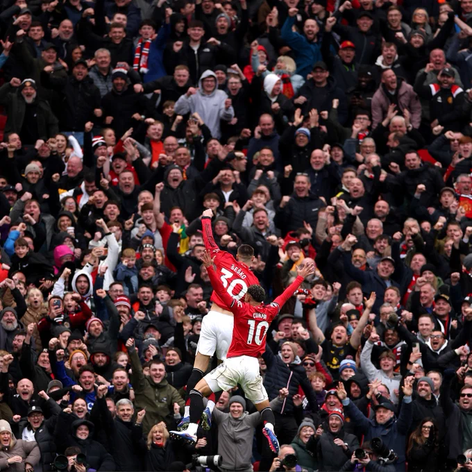 An image of Matheus Cunha and Benjamin Šeško celebrating with the Stretford End.