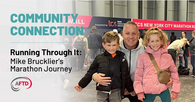 Mike Brucklier and his two children pose outdoors near a "TCS New York City Marathon" banner. The image includes text: "Community Connection," "Running Through It: Mike Brucklier's Marathon Journey." An AFTD logo is visible.