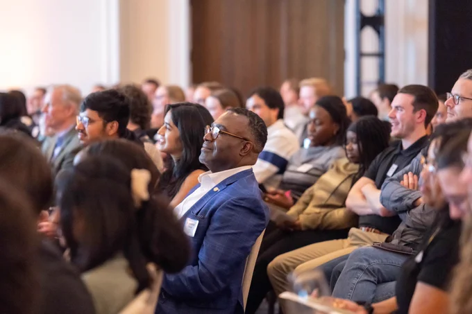 A crowd looks on in the audience