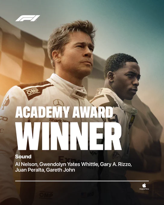 From F1 The Movie. Sonny Hayes, portrayed by Brad Pitt, and Joshua Pearce, portrayed by Damson Idris, stand next to each other on a racetrack wearing racing suits. Text on the image reads, “Academy Award Winner Sound Al Nelson, Gwendolyn Yates Whittle, Gary A. Rizzo, Juan Peralta, Gareth John” On the top left of the image is the F1 logo, and on the bottom right is the Apple logo with “Original Films” written under it.