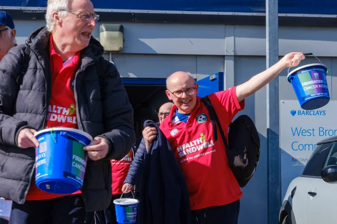 Cancer Kickers participants leaving the Community Sports Hall with buckets in hand.