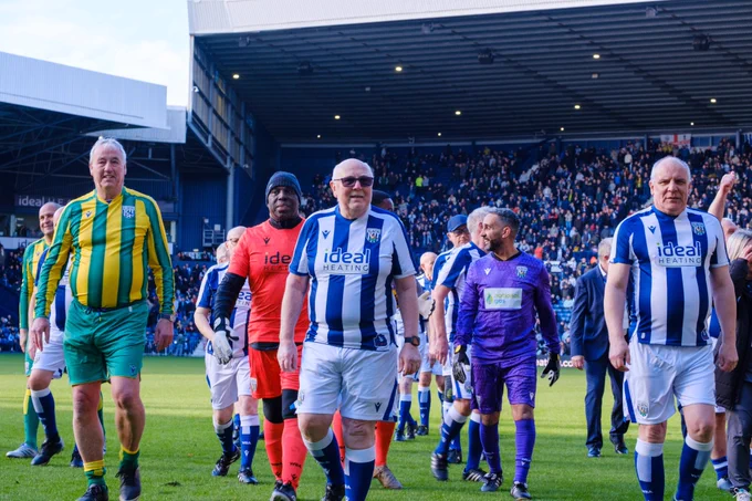 Cancer Kickers participants and WBA Former players leaving the pitch to a warm reception from Baggies Fans.