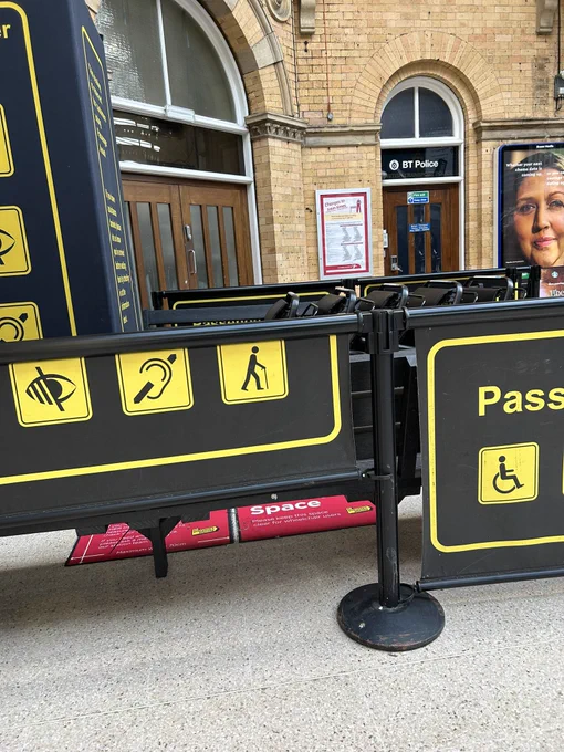 Passenger assistance surrounds pushed into corner around row of wheelchairs with nowhere to sit down