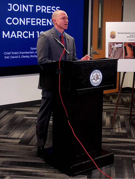 DEA Special Agent in Charge David Olesky speaks with the media from a podium