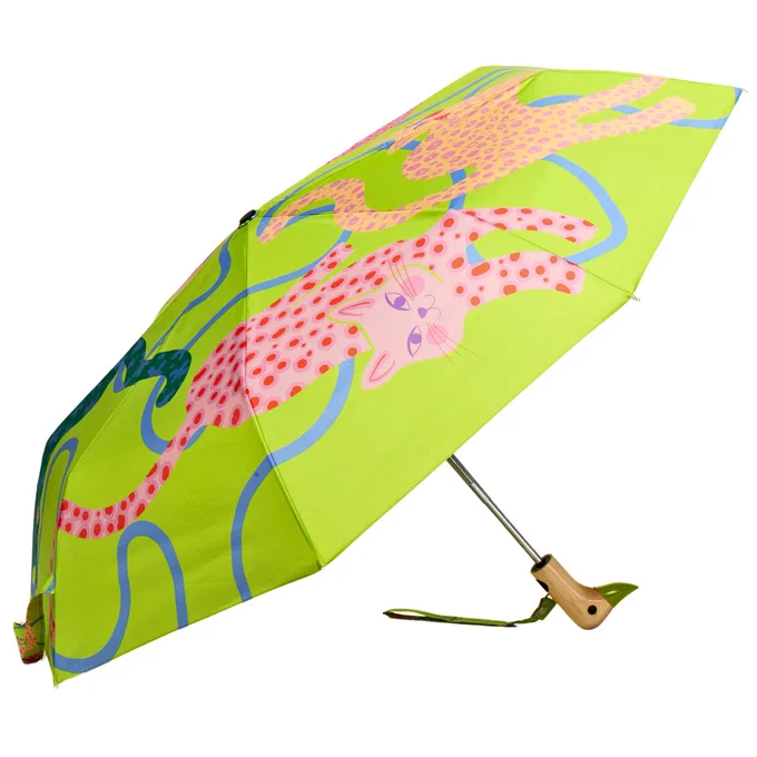 A bright, lime-green umbrella featuring two pink, spotted cats and blue squiggles. The umbrella has a wooden handle and a wrist strap.