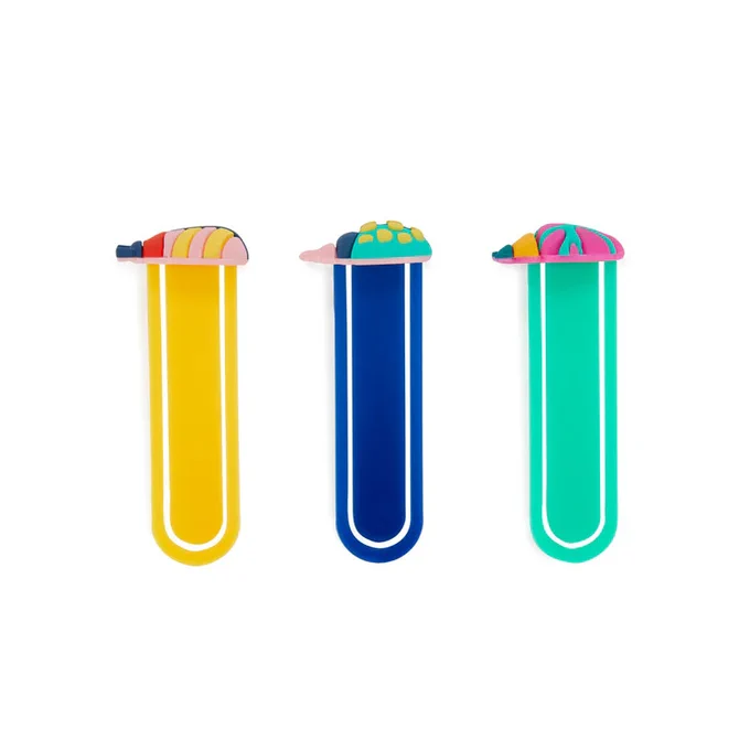 Three long, colorful surfboard bookmarks are displayed vertically against a white background. Each bookmark has a small, decorative surfboard on top in vibrant patterns. They are colored yellow, blue, and green.