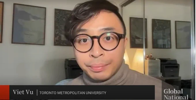 An image of a man wearing a turtleneck and glasses with a name card reading Viet Vu, Toronto Metropolitan University