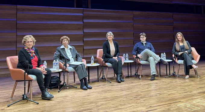 Five people sitting on stage