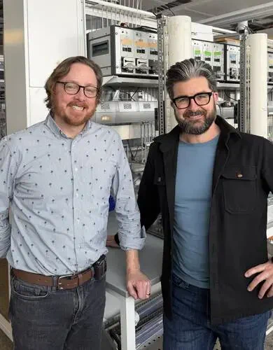 Dr. Michael Parkins (left), Dr. Casey Hubert (right) in a data centre.