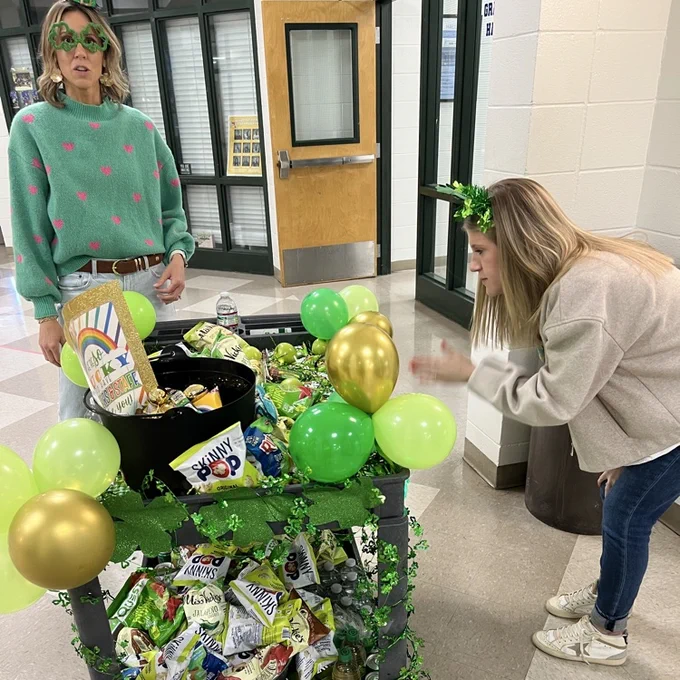 Teachers choose a treat off the cart. 