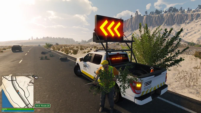 A screenshot from the game Flashing Lights, showing a Department of Transportation truck and department employee clearing up vegetation from the road and putting it in his truck. The truck also has a portable road sign which is pointing left to direct traffic around the vegetation on the road. This is a sandy environment with a road going through the middle. Trees can be seen atop a ridge in the background.