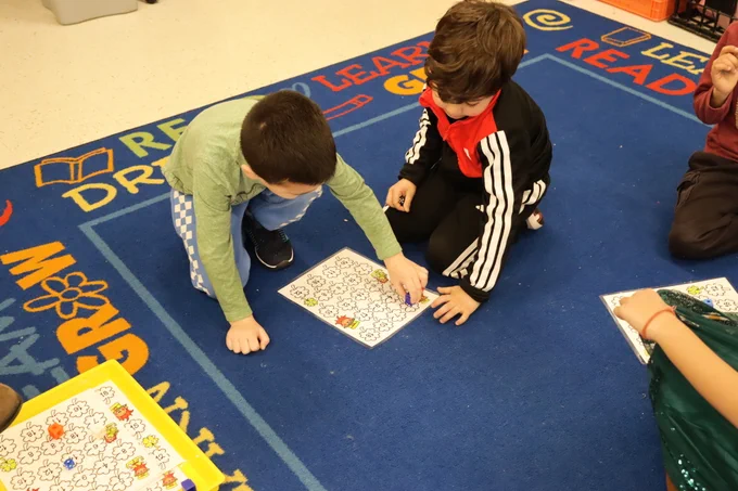 two students working on a st pattys day activity