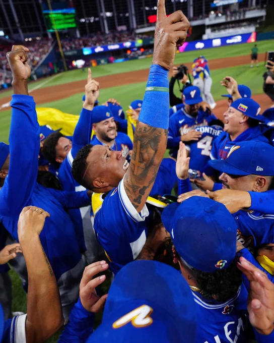 Salvador Perez points to the sky while in the middle of Team Venezuela's World Baseball Classic Championship celebration. (Photo by Daniel Shirey/WBCI/MLB Photos via Getty Images)