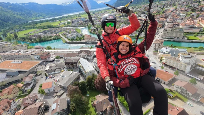 Jenny Castor smiles as she soars through the air with a skydiving instructor during a study abroad trip.