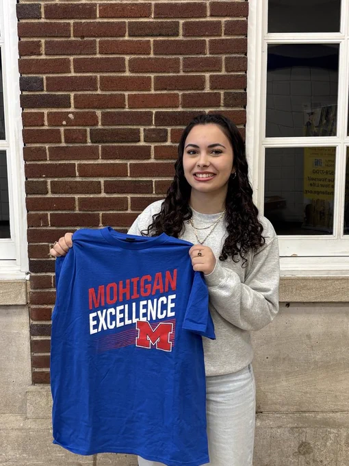 Student holding a shirt 