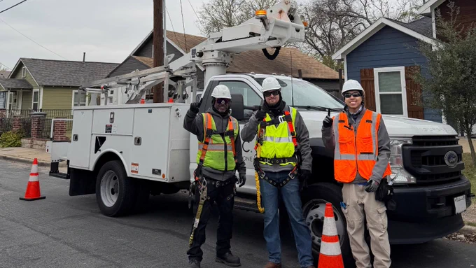 Three Sonic drop crew team members (L to R Charles, Nick, and Miguel) standing together smiling in front of one of the Sonic trucks after our first Dallas member's home was successfully hooked up with 10 Gig internet.   