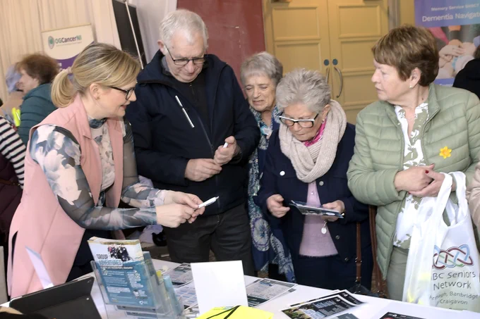 A group of people at one of the exhibition stands at the keep safe keep well events