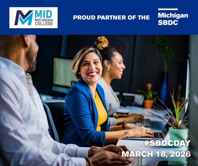 Three professionals collaborate at a computer workstation in an office setting, highlighting Mid Michigan College's partnership with Michigan SBDC.