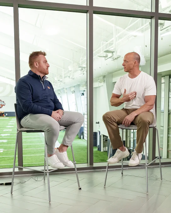 Photos of Head Coach Alex Golesh and Josh pate during an interview at the Woltosz Football Performance Center