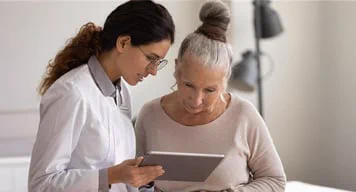 Two women looking at a tablet