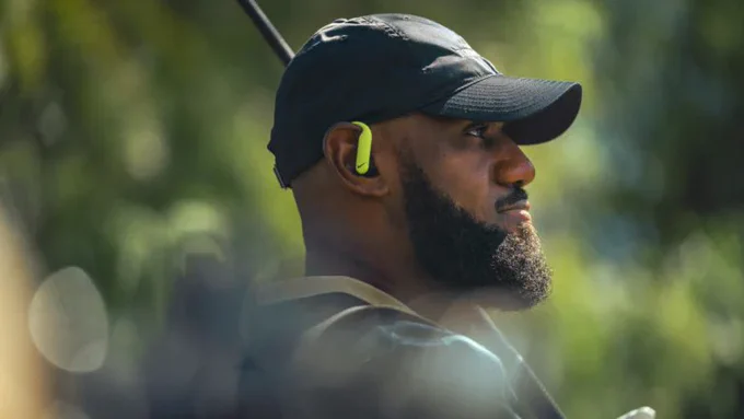 NBA legend LeBron James demonstrates the secure-fit earhooks of the Powerbeats Pro 2 on the golf course.