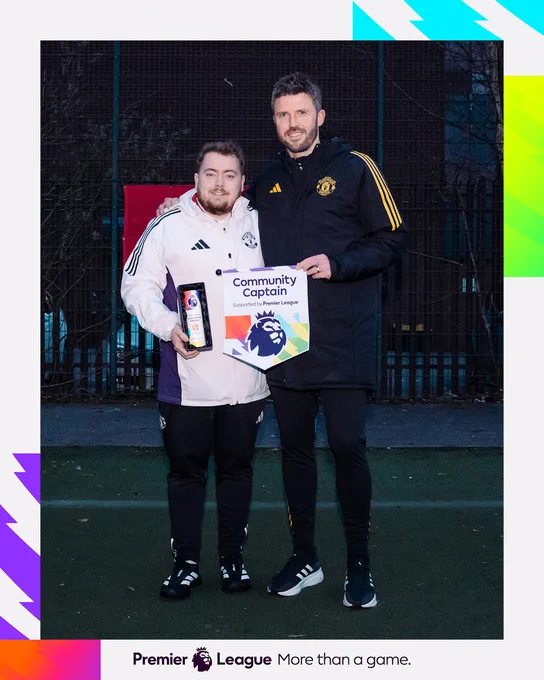 Michael Carrick and Mark Brent hold up the Premier League Community Captain pennant and trophy.