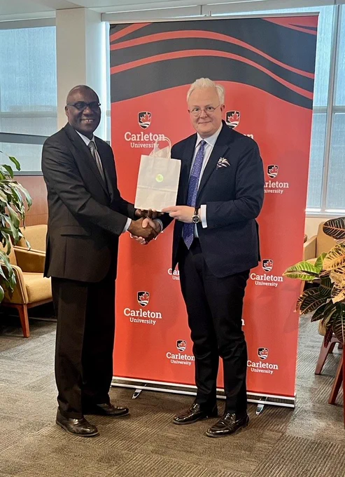 Carleton President Wisdom Tettey shakes hands with His Excellency Jean Claude Kugener, Ambassador of Luxembourg to Canada
