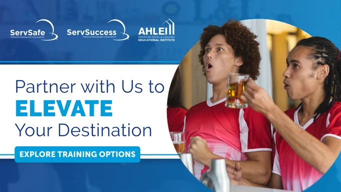 This image features two people wearing red jerseys, raising beer mugs in a celebratory manner. The background displays logos for ServSafe, ServSuccess, and AHLEI. The text reads: "Partner with Us to Elevate Your Destination - Explore Training Options."