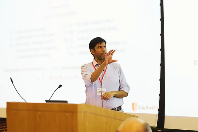 AI3 Director Lav Varshney gives a talk from behind a podium. 