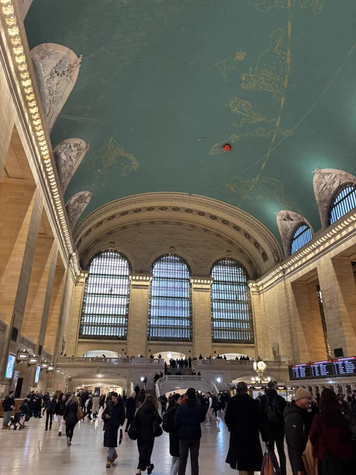 a red heart-shaped balloon on the ceiling in grand central terminal