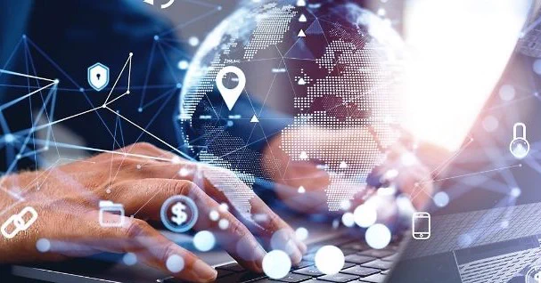 Illustration of hands typing on a laptop with a digital globe, network lines, and technology icons overlaid, representing global connectivity and data exchange.