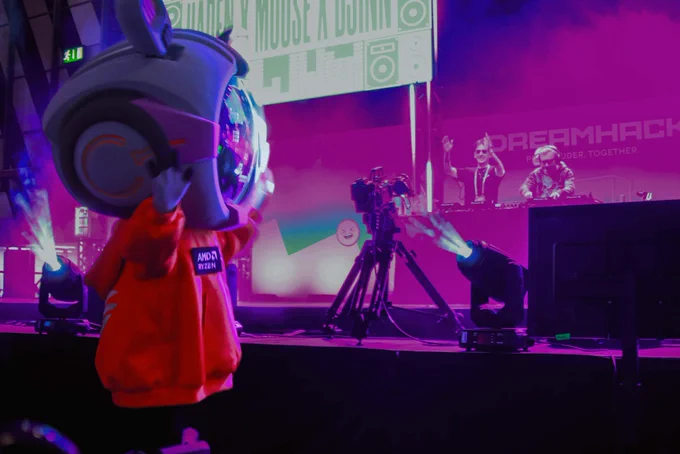 A shot from front of stage where you can see the AMD mascot dancing and Moose, Haden and Djinn are playing their set.