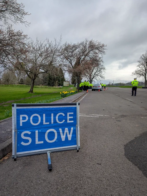A POLICE SLOW sign on the skid pan.