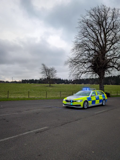 A marked police vehicle being driven on the skid pan.