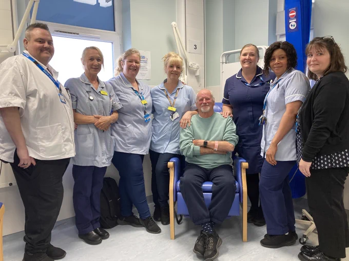 Charles sits having immunotherapy, flanked by staff from Clacton Hospital's Jubilee Unit.